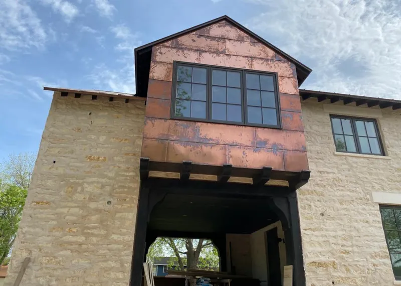 Copper metal panel facade on a stone building for Roof Repair in Rancho San Diego