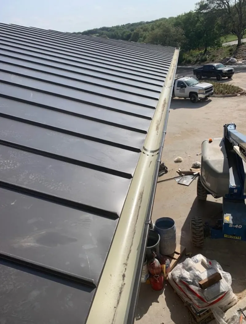 Standing seam panel and gutter detail on a metal roofing jobsite in Rancho San Diego